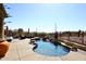 Inviting backyard pool area with lush landscaping, rock features, and desert views at 36674 N Vasari Dr, Scottsdale, AZ 85262