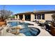 Stunning backyard featuring a luxurious pool, rock features, and outdoor seating areas at 36674 N Vasari Dr, Scottsdale, AZ 85262
