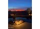 Backyard swimming pool at dusk surrounded by lush desert landscaping and rocks at 36674 N Vasari Dr, Scottsdale, AZ 85262