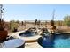 Resort-style pool with a rock waterfall feature and lush desert landscaping at 36674 N Vasari Dr, Scottsdale, AZ 85262