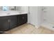 Bathroom with double vanity, granite countertops, and a glass-enclosed shower at 42099 W Balsa Dr, Maricopa, AZ 85138