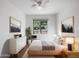 Comfortable bedroom with a large window, stylish furnishings, and ample natural light at 42099 W Balsa Dr, Maricopa, AZ 85138