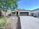 Charming single-story home featuring a well-maintained front yard and a two-car garage at 42099 W Balsa Dr, Maricopa, AZ 85138