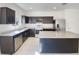 Kitchen with granite countertops, stainless steel appliances, and dark cabinetry at 42099 W Balsa Dr, Maricopa, AZ 85138