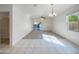Bright living room featuring large windows, neutral carpet, and a sliding glass door at 42099 W Balsa Dr, Maricopa, AZ 85138