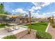 Large backyard with artificial grass, picnic table, trampoline and comfortable outdoor seating at 4410 S Grandview Ave, Tempe, AZ 85282