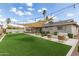 Expansive backyard with artificial grass, patio area, and comfortable outdoor seating at 4410 S Grandview Ave, Tempe, AZ 85282