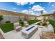 Inviting backyard featuring a modern fire pit, manicured lawn, patio furniture, and stylish shade covers perfect for outdoor living at 4410 S Grandview Ave, Tempe, AZ 85282