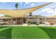 Spacious backyard with artificial grass, outdoor dining, fire pit, and comfortable seating at 4410 S Grandview Ave, Tempe, AZ 85282