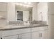 Bathroom featuring double sinks, granite countertops, and white cabinets offering plenty of storage space at 4410 S Grandview Ave, Tempe, AZ 85282