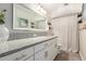 Bright bathroom featuring a granite countertop, large mirror, and shower with a decorative curtain at 4410 S Grandview Ave, Tempe, AZ 85282