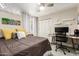 Bedroom with decorative ceiling fan, cozy carpet, and closet with white louvered doors at 4410 S Grandview Ave, Tempe, AZ 85282