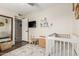Inviting bedroom featuring a crib, dresser, mirror, chair and decorative elements at 4410 S Grandview Ave, Tempe, AZ 85282