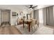 Elegant dining area featuring a modern table, plush chairs, stylish decor, and light hardwood floors at 4410 S Grandview Ave, Tempe, AZ 85282