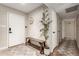 Bright foyer featuring a patterned accent wall, light wood floors, and a rustic wooden bench at 4410 S Grandview Ave, Tempe, AZ 85282