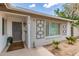 Inviting front entrance showcasing a gray painted door, decorative wall art, and minimalist landscaping at 4410 S Grandview Ave, Tempe, AZ 85282
