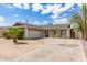 Charming single-story home with desert landscaping, a two-car garage, and a curved driveway under a partly cloudy sky at 4410 S Grandview Ave, Tempe, AZ 85282