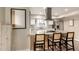 Bright kitchen with granite counters, stainless steel appliances, breakfast bar and modern hood vent at 4410 S Grandview Ave, Tempe, AZ 85282