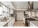 Updated kitchen features white cabinets, granite counters, stainless appliances, and new luxury vinyl plank flooring at 4410 S Grandview Ave, Tempe, AZ 85282