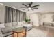 Inviting living area showcasing a large sectional sofa, cozy decor, and a modern ceiling fan at 4410 S Grandview Ave, Tempe, AZ 85282