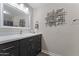 Bathroom featuring a single vanity, large mirror and striking modern art at 5735 E Mcdowell Rd # 388, Mesa, AZ 85215