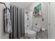 Bathroom featuring a shower and bathtub combination, toilet, and decorative art at 5735 E Mcdowell Rd # 388, Mesa, AZ 85215