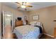 Comfortable bedroom featuring floral bedding, ceiling fan and classic wood furnishings at 5735 E Mcdowell Rd # 388, Mesa, AZ 85215