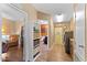 Hallway featuring a view of the laundry room, a half bathroom, and access to the living area at 5735 E Mcdowell Rd # 388, Mesa, AZ 85215