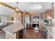 Bright kitchen showcases stainless steel appliances, backsplash, and center island, complemented by wood floors at 5735 E Mcdowell Rd # 388, Mesa, AZ 85215
