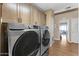 Laundry area featuring a washer and dryer and overhead storage cabinets at 5735 E Mcdowell Rd # 388, Mesa, AZ 85215
