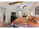 Spacious main bedroom featuring a ceiling fan, natural light, wood floors, a dresser, and a TV at 5735 E Mcdowell Rd # 388, Mesa, AZ 85215
