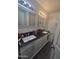 Well-lit bathroom with double sinks, granite countertops, and updated fixtures at 6010 W Coolidge St, Phoenix, AZ 85033