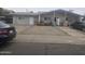 Simple single-story duplex featuring neutral paint, gravel yard, and covered parking at 6010 W Coolidge St, Phoenix, AZ 85033