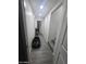 This hallway features tiled floors, neutral paint, and access to the home's stairway at 6010 W Coolidge St, Phoenix, AZ 85033