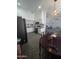 Open-concept kitchen with white cabinets, black appliances, and adjacent dining area at 6010 W Coolidge St, Phoenix, AZ 85033