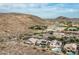 Aerial view of neighborhood featuring desert landscaping, mountains, tennis courts, community pool, and residential homes at 6326 W Misty Willow Ln, Glendale, AZ 85310