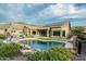 Beautiful backyard with a refreshing pool, turf lawn, covered patio, and well-manicured landscaping at 6326 W Misty Willow Ln, Glendale, AZ 85310