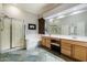Bathroom featuring double sinks, soaking tub, and glass-enclosed shower at 6326 W Misty Willow Ln, Glendale, AZ 85310
