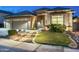 Inviting home exterior showcases a three-car garage, stone accents, and desert landscaping at 6326 W Misty Willow Ln, Glendale, AZ 85310