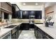 Bright kitchen with dark cabinets, stainless appliances, stone counters, and decorative backsplash at 6326 W Misty Willow Ln, Glendale, AZ 85310