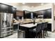 Well-equipped kitchen boasting dark cabinetry, stainless steel appliances, and a stylish backsplash at 6326 W Misty Willow Ln, Glendale, AZ 85310