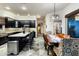 Open concept kitchen and dining area with elegant finishes and access to the backyard at 6326 W Misty Willow Ln, Glendale, AZ 85310