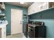 Well-organized laundry room with white cabinets, modern washer and dryer, and tile floors at 6326 W Misty Willow Ln, Glendale, AZ 85310