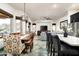 Open concept living and dining area with tile floors, pendant lighting, and access to the backyard at 6326 W Misty Willow Ln, Glendale, AZ 85310