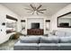 Cozy living room features a plush sofa, media center, and views of the backyard patio at 6326 W Misty Willow Ln, Glendale, AZ 85310