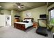 Spacious main bedroom with a cozy bed, dresser, and access to the ensuite bathroom at 6326 W Misty Willow Ln, Glendale, AZ 85310
