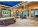 Covered outdoor patio featuring comfortable seating, brick flooring and seamless indoor/outdoor living at 6326 W Misty Willow Ln, Glendale, AZ 85310
