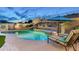 Inviting pool area featuring a waterfall, lush landscaping, and comfortable lounge seating at 6326 W Misty Willow Ln, Glendale, AZ 85310