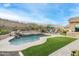 Stunning pool with waterfall feature, lush landscaping, turf lawn, and outdoor seating area at 6326 W Misty Willow Ln, Glendale, AZ 85310