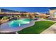 Beautiful pool with a waterfall feature, lush landscaping, and outdoor lounge seating, perfect for relaxation at 6326 W Misty Willow Ln, Glendale, AZ 85310